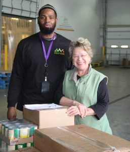 Patty Wudel and Ricardo, a food bank employee