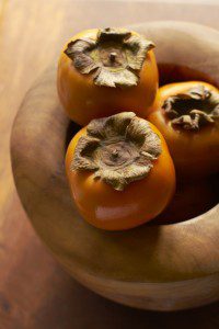 Persimmon In Wooden Bowl